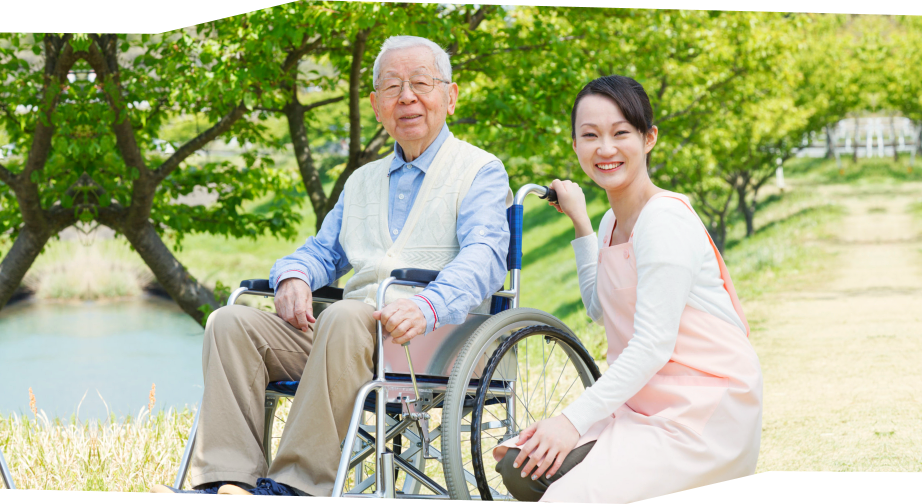 caregiver and senior man in wheelchair smiling